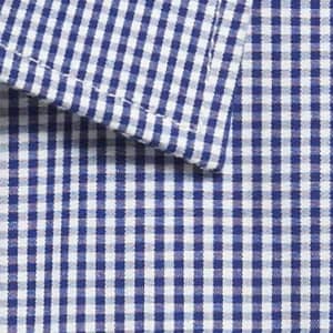 A close-up of a blue and white gingham fabric with a button-up shirt collar detail, featuring a logo.