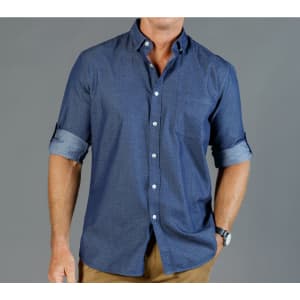 A button-up shirt in navy chambray with rolled-up sleeves and a subtle pattern, featuring a logo.