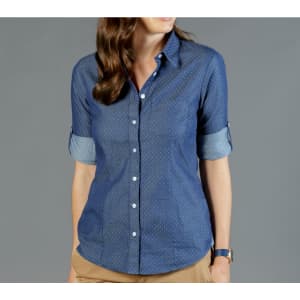 A blue button-up shirt featuring a chambray design with rolled sleeves and a subtle dotted pattern.