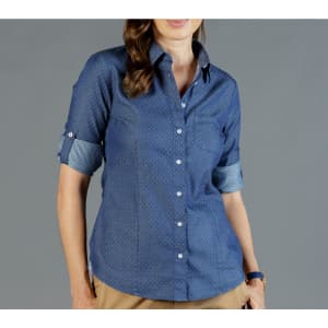 A blue chambray button-up shirt with rolled cuffs and a chest pocket, featuring a subtle pattern.