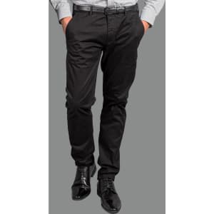 A pair of black chinos worn with a light-coloured shirt and black shoes, featuring a belt and a logo.