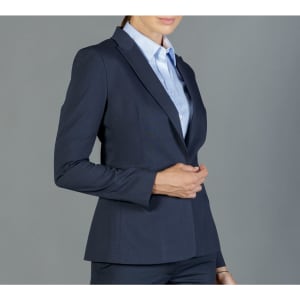 A fitted navy blazer with a structured silhouette, paired with a light blue shirt, featuring a branding logo.