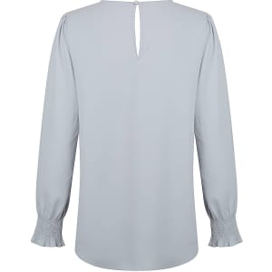 A light grey blouse with long shirred cuffs and a back keyhole detail. It has a simple, elegant design.