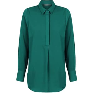 A green shirt with a half placket and long sleeves, featuring a collar and a logo.