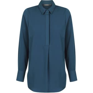 A dark teal shirt with a half placket and long sleeves, featuring a collar and a branding logo.