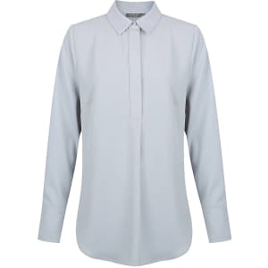 A light grey long-sleeve shirt with a half placket and a collar, featuring a logo on the label.