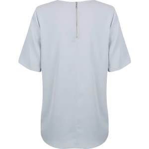 A light blue short sleeve shirt featuring a back zip closure and a simple design. It has a logo on it.