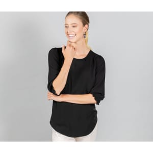 A black blouse with shirred cuffs, featuring a relaxed fit and a rounded neckline, worn by a smiling model.