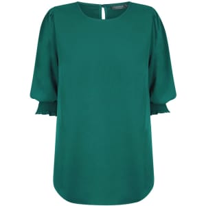 A green top with shirred cuffs and a keyhole back, featuring a relaxed fit and smooth fabric.