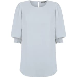 A light blue blouse featuring shirred cuffs and a subtle back closure. The design has a relaxed fit with soft fabric.