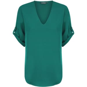 A green V-neck shirt with rolled sleeves and a relaxed fit, featuring a subtle logo.