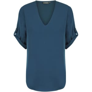 A teal V-neck shirt with rolled-up sleeves and a smooth, structured design. It has a brand logo on the label.