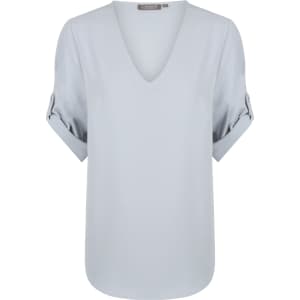 A light blue V-neck shirt with rolled sleeves and a smooth finish. It features a branding label at the neckline.