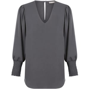 A grey Cleo V Neck shirt featuring a v-neckline and puffed sleeves with smocked cuffs. It has a logo tag.