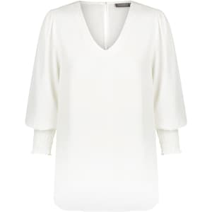 A white v-neck shirt with puff sleeves and gathered cuffs, featuring a back zip closure and a logo.