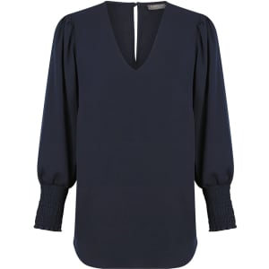 A navy blue V-neck shirt with puffed sleeves and smocked cuffs. Includes a branding logo on the neckline.