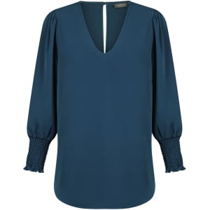 A teal V-neck shirt with puffed sleeves and smocked detailing at the cuffs, featuring a keyhole back.