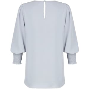 A light grey shirt featuring a keyhole back and smocked sleeves, with a smooth, flowing design.