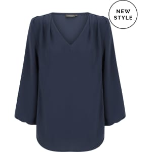 A navy blue V-neck popover shirt with long sleeves and pleated detailing. It features a logo in the corner.