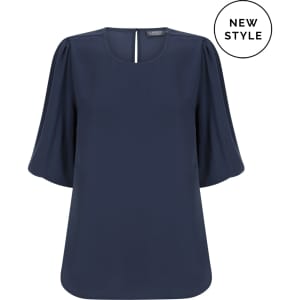 A navy Poppy Puff Sleeve Top, featuring a round neckline and puff sleeves, with a logo present on the design.