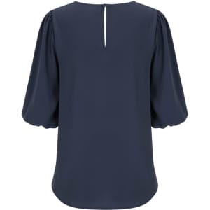 A navy poppy puff sleeve top with a keyhole back detail, featuring voluminous sleeves and a smooth finish.