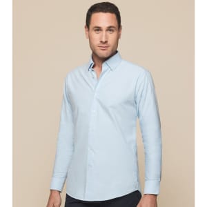 A light blue button-up shirt with a collar, featuring long sleeves and a logo on the upper chest.