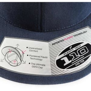 A navy blue Flexfit 110 cap featuring a tag with details about its patented technology and a logo.