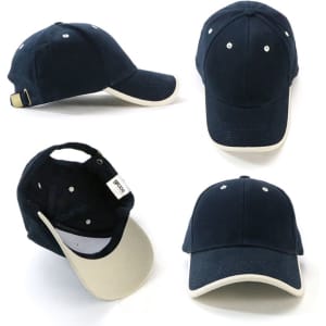  Navy cap with a cream brim and a branding tag, featuring stitched ventilation holes and an adjustable strap at the back.