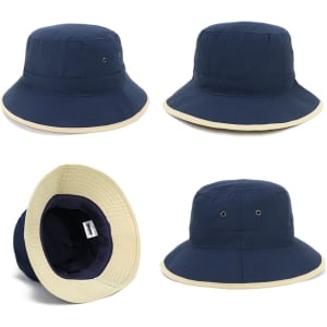 A navy microfibre bucket hat with a cream trim, featuring interior lining and a logo.