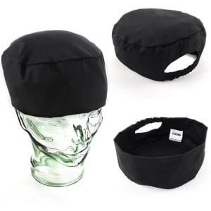 A black polycotton chef's hat displayed from multiple angles on a model head. It features an elastic back and branding.
