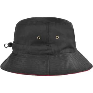 A reversible black bucket hat with an adjustable toggle and gold eyelets, featuring a red trim.