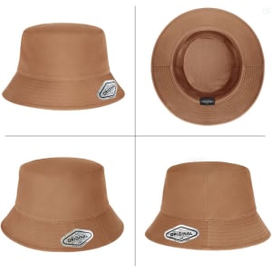 A tan premium bucket hat featuring a label and a smooth finish, with a wide brim and a textured interior.