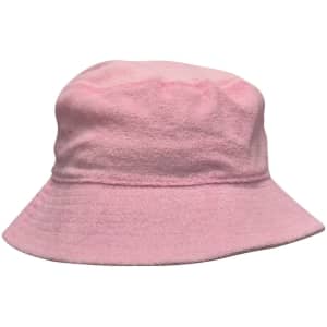 A pink terry towelling bucket hat with a soft texture and a wide brim. It features a logo.