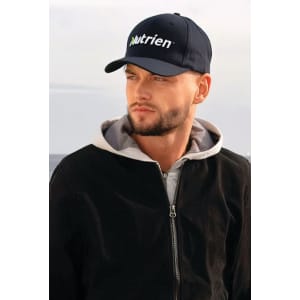 A navy blue cap with a logo, worn by a man in a black jacket and grey hoodie.