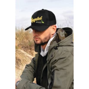 A black cap with a mesh back and a logo featuring the word "Recycled," worn by a person in an outdoor setting.