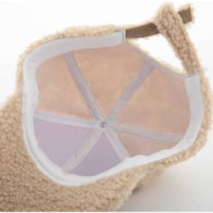 A personalised lamb wool baseball cap in beige, showcasing a soft interior with a central seam and adjustment strap.
