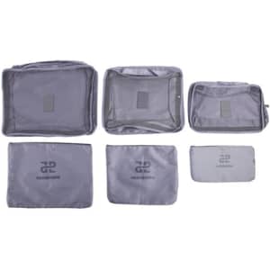 A set of six grey travel storage bags in various sizes, featuring a logo on some bags.