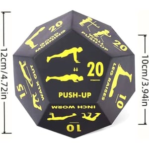 A large black foam die featuring various fitness exercise illustrations and numbers on its sides.
