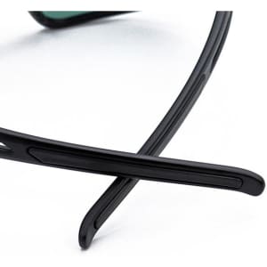 Black outdoor sports cycling glasses with sleek arms and tinted lenses. Detailed design highlighting the frame's structure.