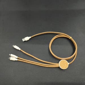 A 3-in-1 charging cable featuring a cork and wheat straw design, in shades of beige and brown, with multiple connectors.