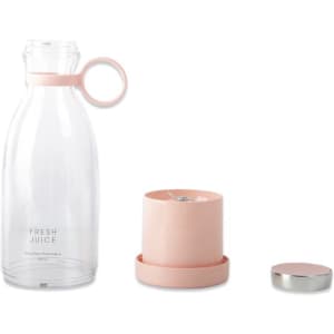 A pink portable personal blender with a clear drink bottle and a detachable blending cup. Includes a lid.