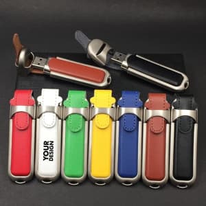 A collection of 4G leather USB flash drives in various colours including red, blue, yellow, white, and black, with metallic accents.