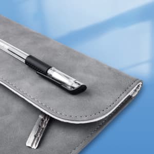 A grey laptop sleeve with a pen resting on top, featuring a logo.