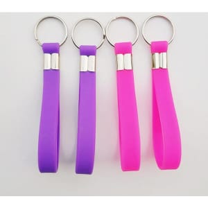 A set of silicone keychain wristbands in purple and pink, featuring metal keyring attachments.