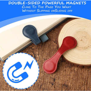 A PU leather magnetic bookmark in navy blue and red resting on a wooden surface next to a notebook.