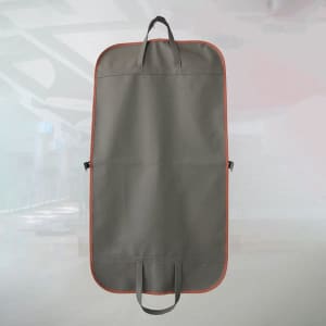 A hanging garment bag in grey with orange trim, featuring handles and a logo.