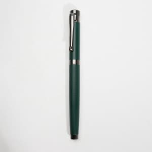 A green fountain pen with a textured grip and silver accents, featuring a clip and a smooth finish.