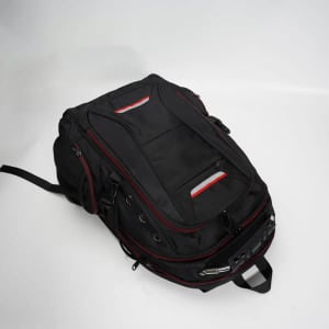 A multifunctional travel laptop backpack in black, featuring red accents and multiple compartments for storage.
