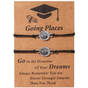 Two stainless steel friendship bracelets on a brown card, featuring a circular charm and black adjustable cords.