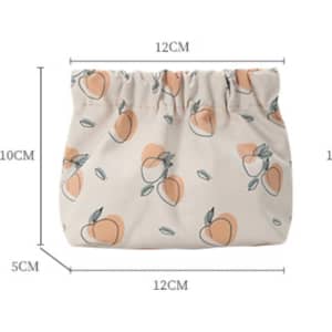 A small cosmetic bag in peach and cream with a gathered top and a floral fruit pattern, featuring dimensions marked on the image.